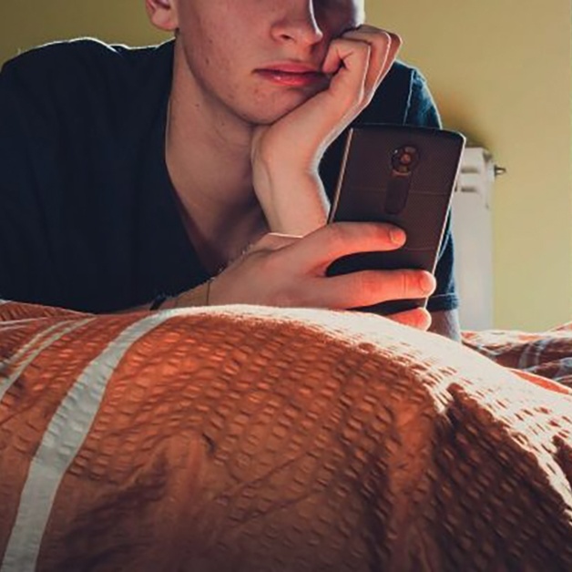 Teenager using phone in bedroom header SEO