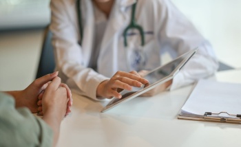 Doctor speaking to patient with an i Pad Website image gallery 1