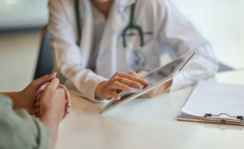 Doctor speaking to patient with an i Pad Website image gallery